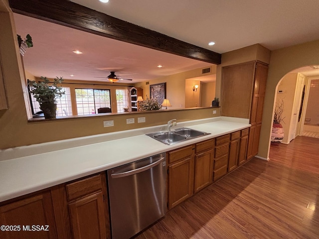 kitchen featuring sink, light hardwood / wood-style flooring, ceiling fan, stainless steel dishwasher, and beamed ceiling