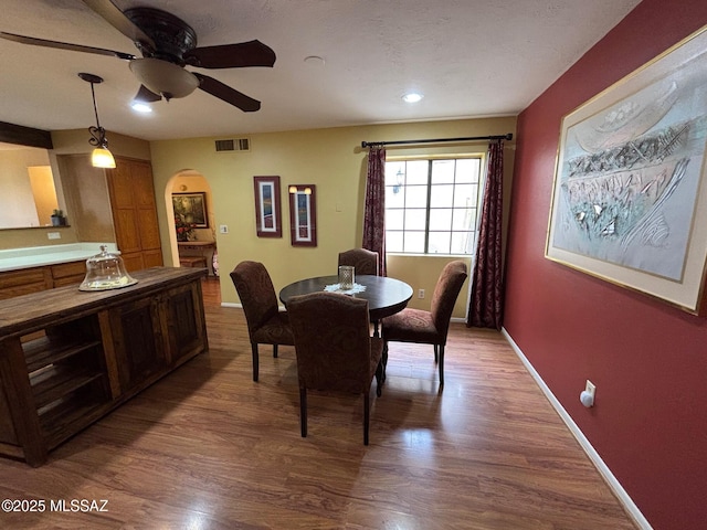 dining room featuring wood-type flooring and ceiling fan