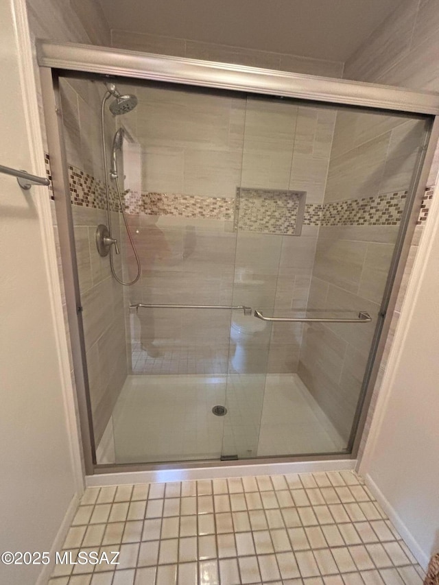 bathroom featuring a shower with door