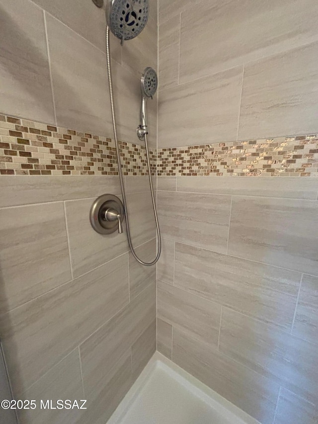 bathroom with a tile shower