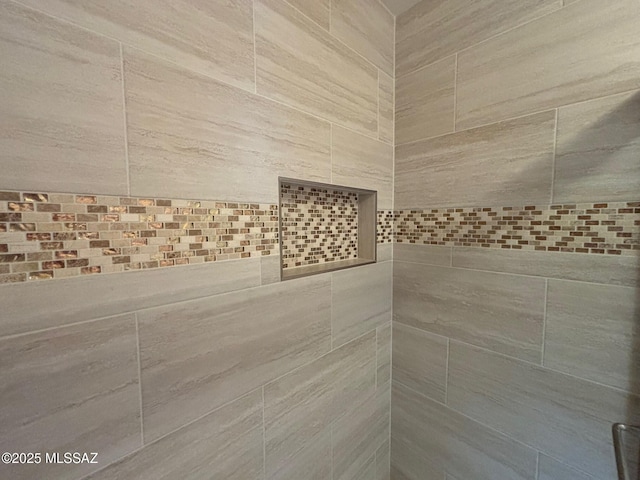 bathroom with tiled shower