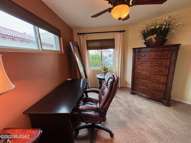 carpeted office space with ceiling fan