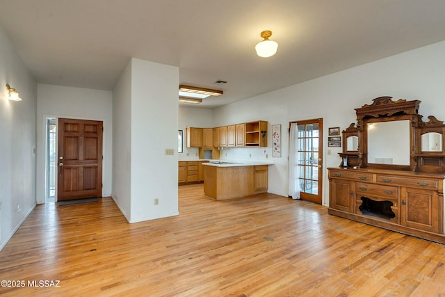 kitchen with kitchen peninsula and light hardwood / wood-style flooring