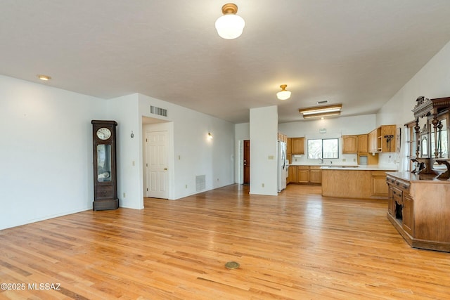 kitchen featuring light hardwood / wood-style floors and white fridge