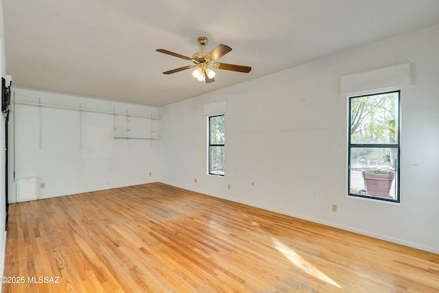 unfurnished room featuring ceiling fan and light wood-type flooring