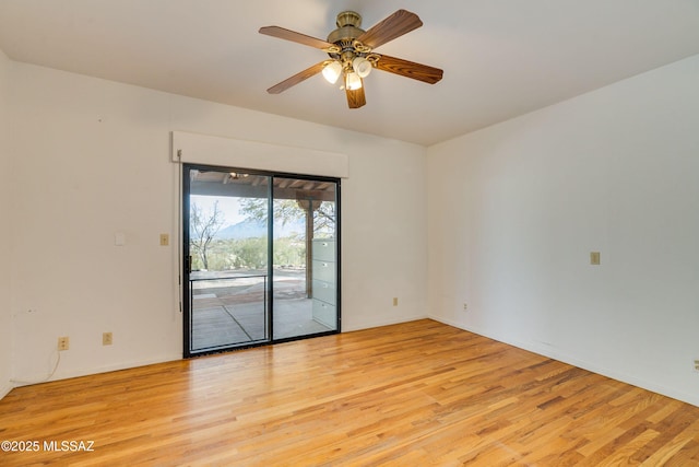 empty room with ceiling fan and light hardwood / wood-style floors