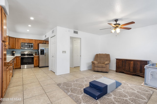 tiled living room featuring ceiling fan