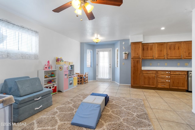 interior space featuring ceiling fan and light tile patterned floors