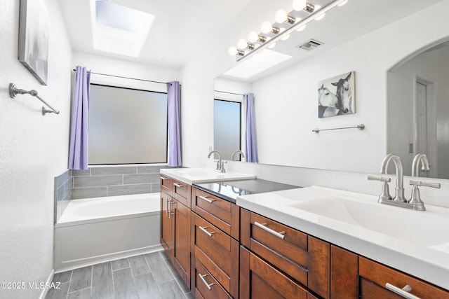 bathroom with vanity and a tub to relax in