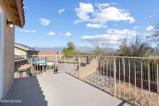 view of patio / terrace with a balcony and a mountain view