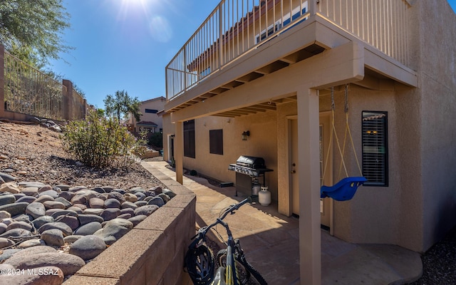 view of patio / terrace with a grill and a balcony