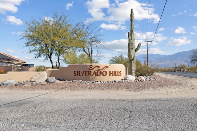 community sign with a mountain view