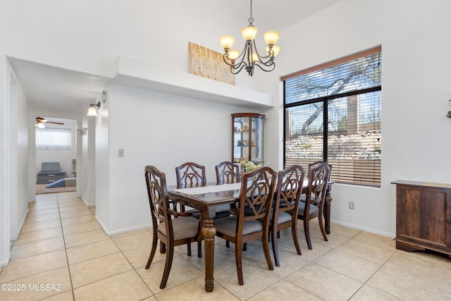 dining space with a wealth of natural light, light tile patterned floors, and a notable chandelier