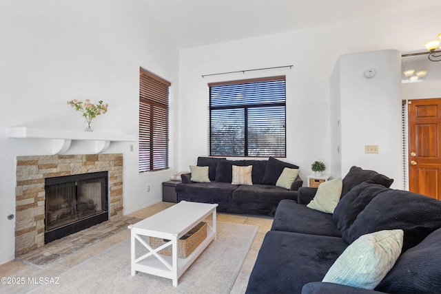 tiled living room with an inviting chandelier and a fireplace