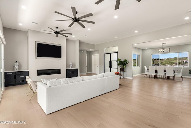 living room with a chandelier and light wood-type flooring