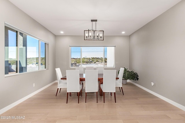 dining space featuring an inviting chandelier and light hardwood / wood-style floors