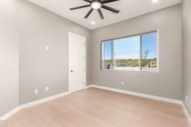 spare room with ceiling fan and light hardwood / wood-style floors