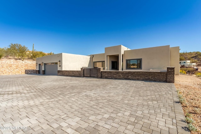 pueblo-style home with a garage