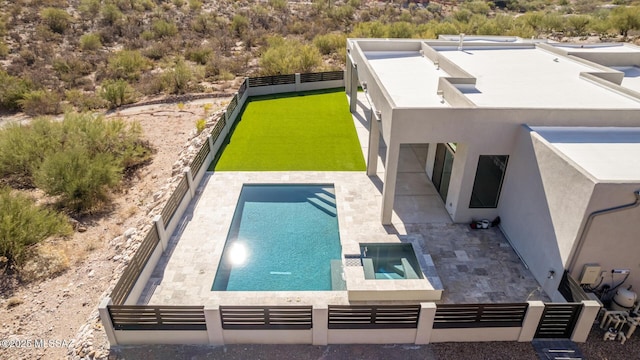 exterior space featuring an in ground hot tub and a patio area