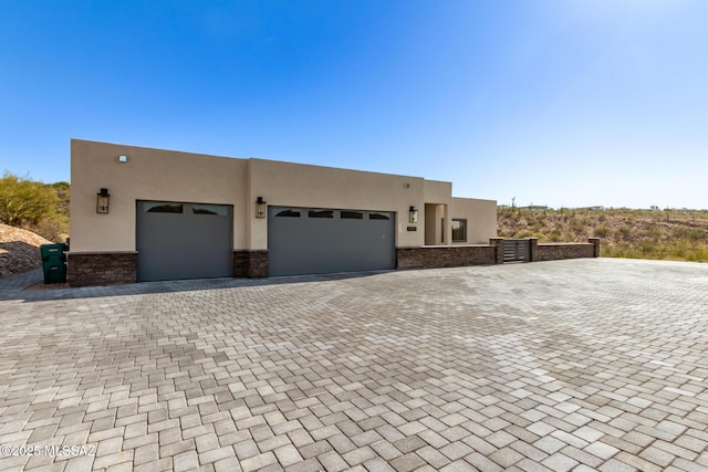 pueblo-style home featuring a garage