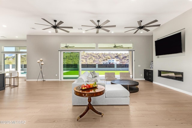 living room with light hardwood / wood-style flooring and a healthy amount of sunlight