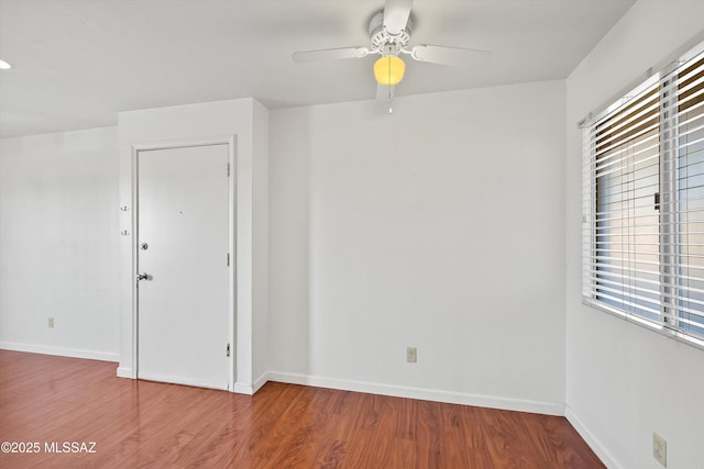 spare room featuring hardwood / wood-style flooring and ceiling fan