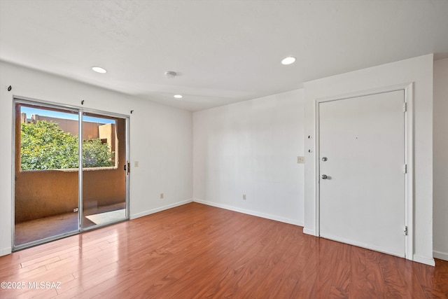 unfurnished room with wood-type flooring