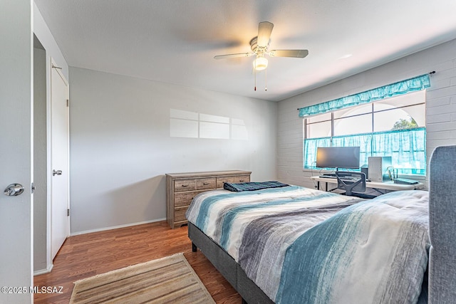 bedroom featuring hardwood / wood-style flooring and ceiling fan