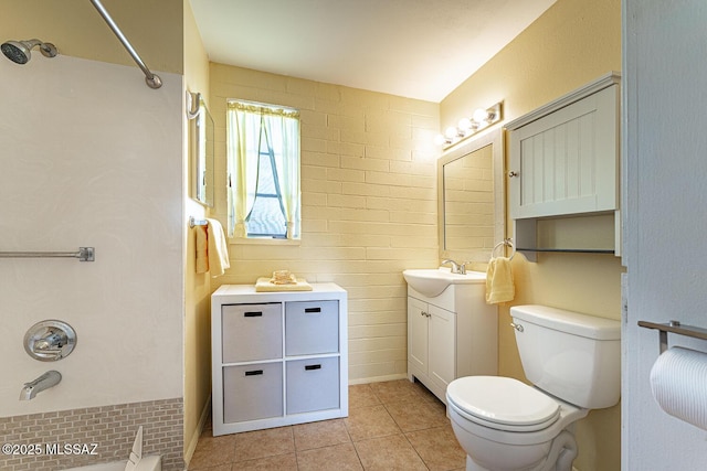 bathroom with toilet, vanity, and tile patterned flooring