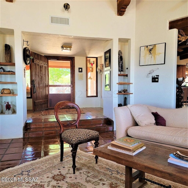 living room featuring dark tile patterned floors