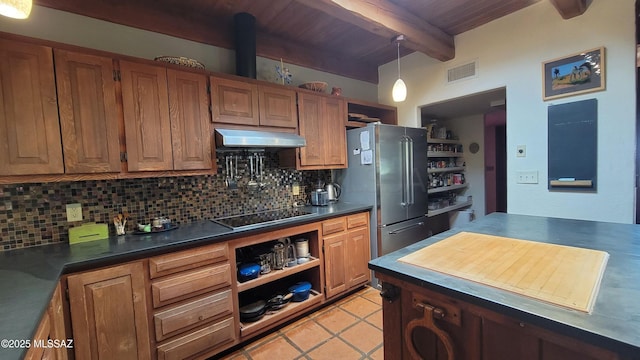 kitchen with light tile patterned flooring, high end refrigerator, black electric cooktop, beamed ceiling, and backsplash