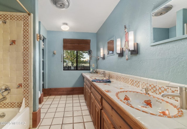 bathroom featuring tiled shower / bath, vanity, and tile patterned floors