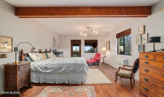 bedroom with light hardwood / wood-style floors and beamed ceiling