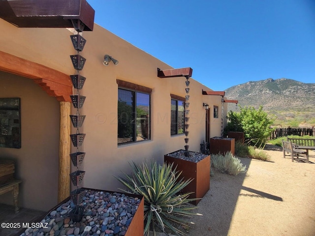 view of property exterior featuring a mountain view