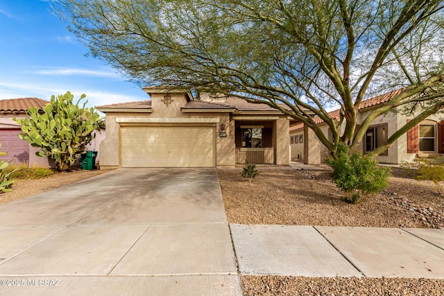 view of front of property featuring a tiled roof, stucco siding, driveway, and a garage