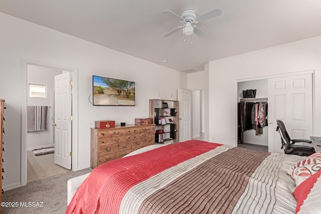 carpeted bedroom with a spacious closet, connected bathroom, ceiling fan, and a closet