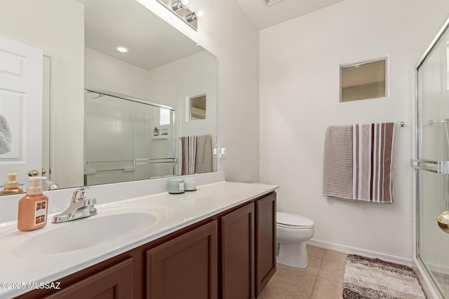 bathroom featuring vanity, tile patterned floors, a shower with door, and toilet