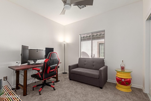 carpeted home office featuring ceiling fan