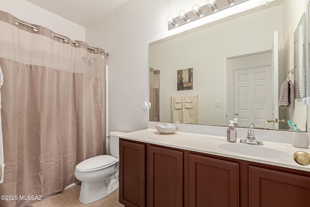 bathroom featuring a shower with shower curtain, vanity, toilet, and tile patterned flooring