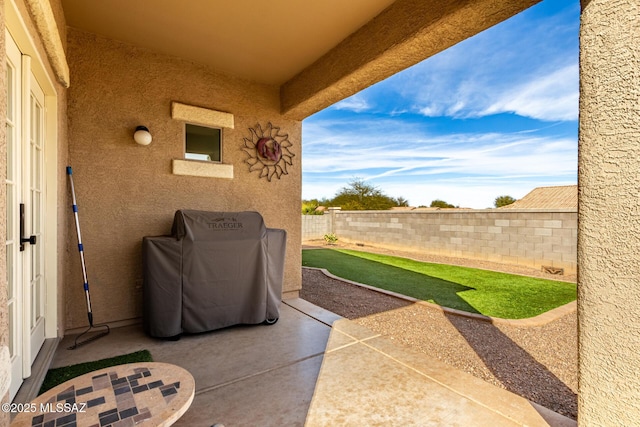 view of patio featuring a grill