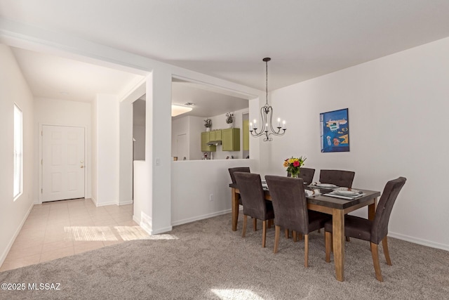 carpeted dining space with a notable chandelier