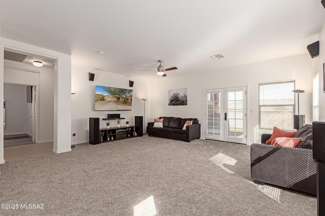 living room with french doors, light colored carpet, and ceiling fan