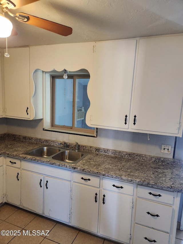 kitchen with white cabinetry, sink, ceiling fan, and light tile patterned flooring