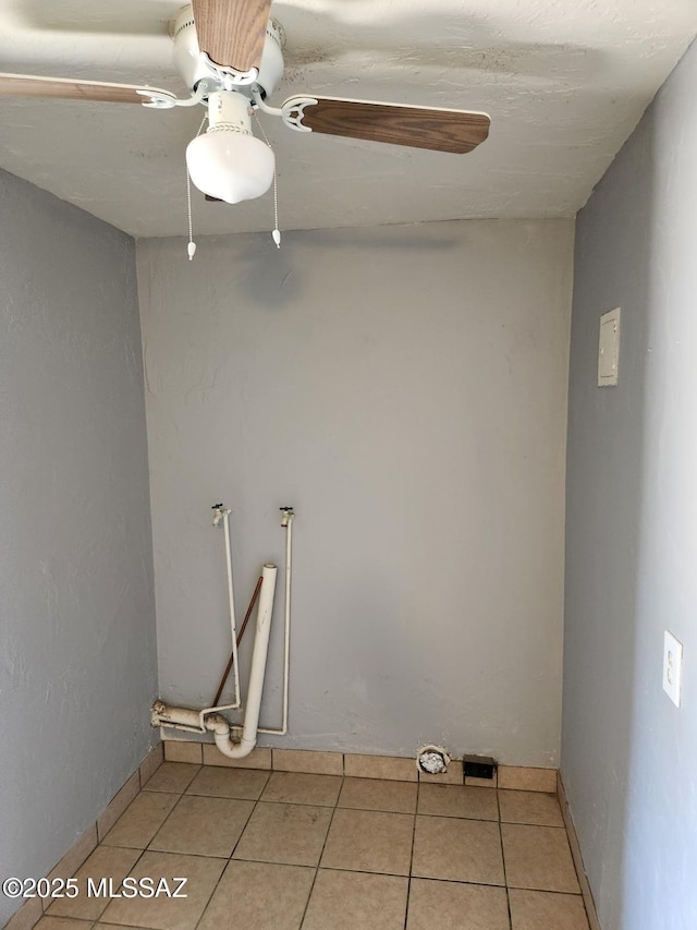 laundry area featuring light tile patterned floors and ceiling fan