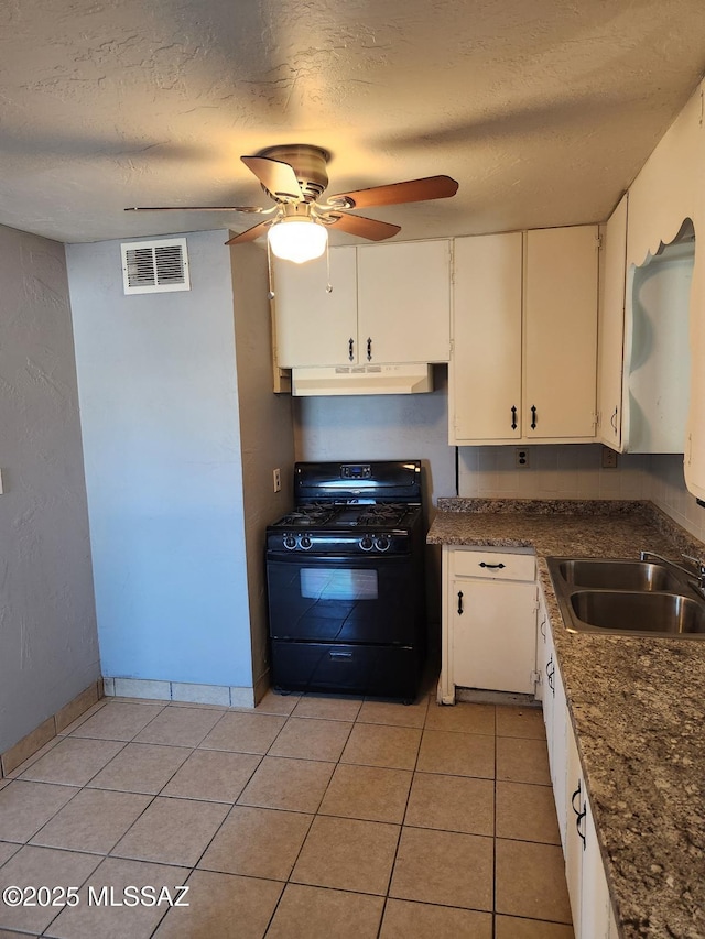 kitchen featuring white cabinetry, sink, gas stove, and a textured ceiling