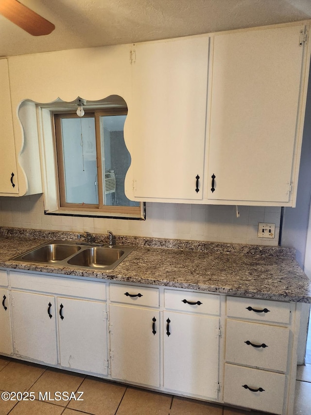 kitchen with white cabinetry and sink