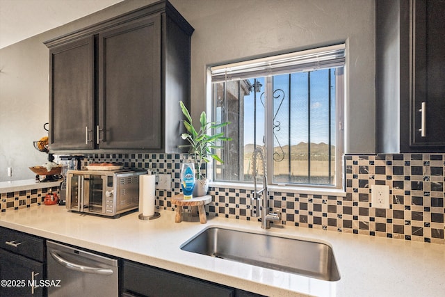 kitchen with tasteful backsplash, dishwasher, sink, and dark brown cabinets