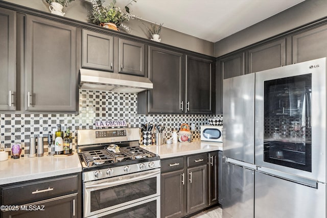 kitchen with dark brown cabinetry, stainless steel appliances, and decorative backsplash