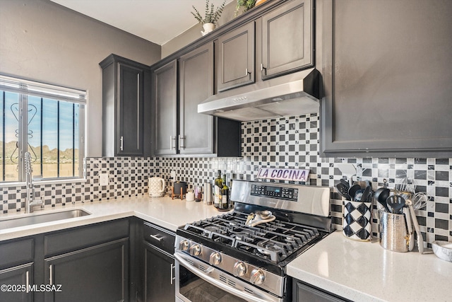 kitchen with sink, backsplash, and stainless steel gas range