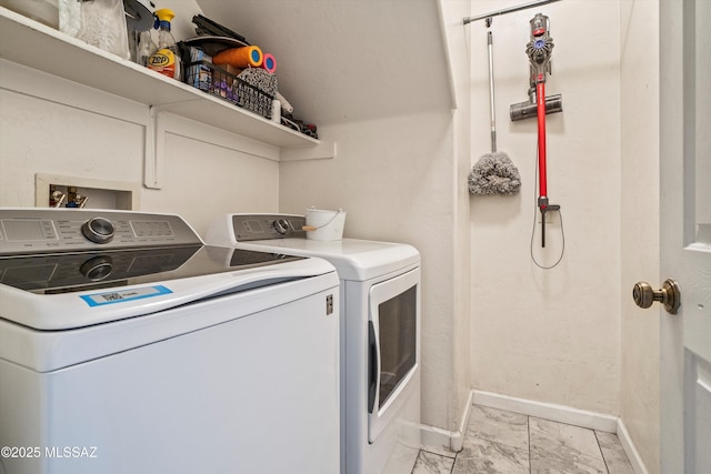 clothes washing area featuring washer and dryer